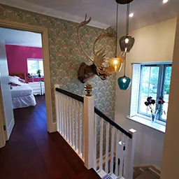 staircase with stag head on wall